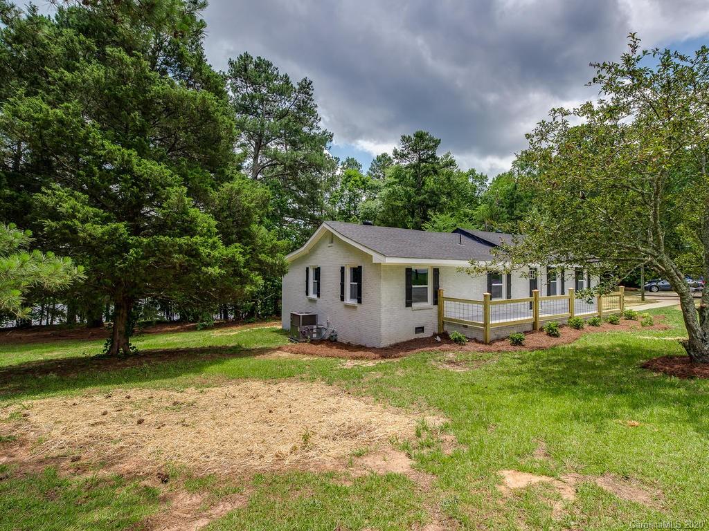 2096 Hardin Strait Road Chester, SC 29706 - Photo 4 of 27 a house that is sitting in the grass with large trees and plants