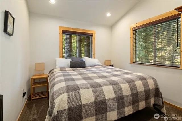 a bedroom with a bed and a large window