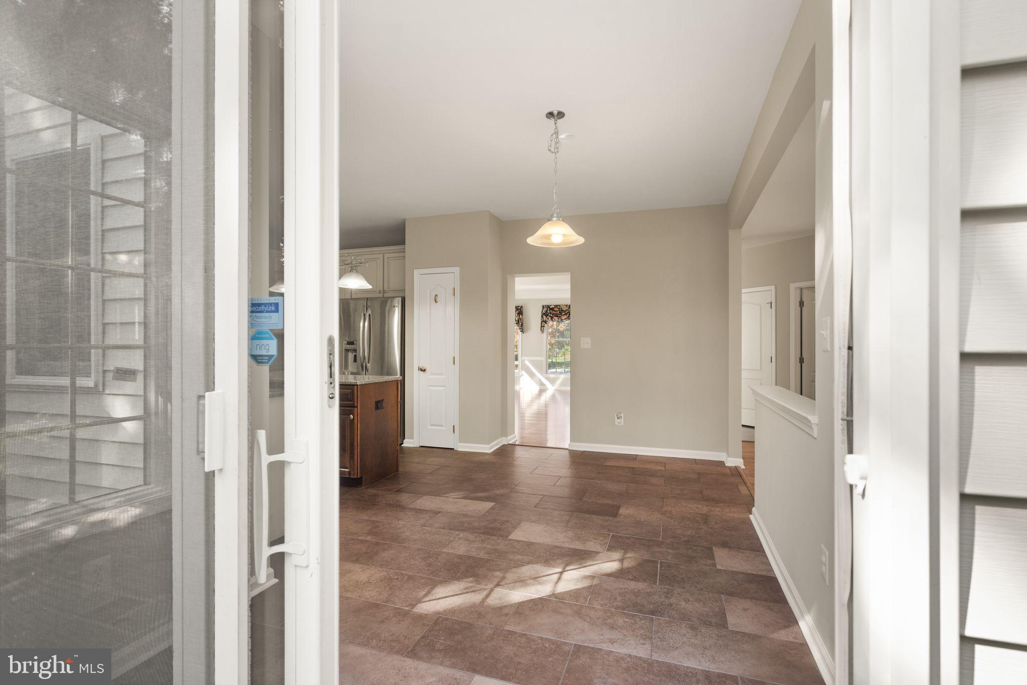 1327 Murray Downs Way Reston, VA 20194 - Photo 15 of 66 a view of a hallway with wooden floor and a bathroom