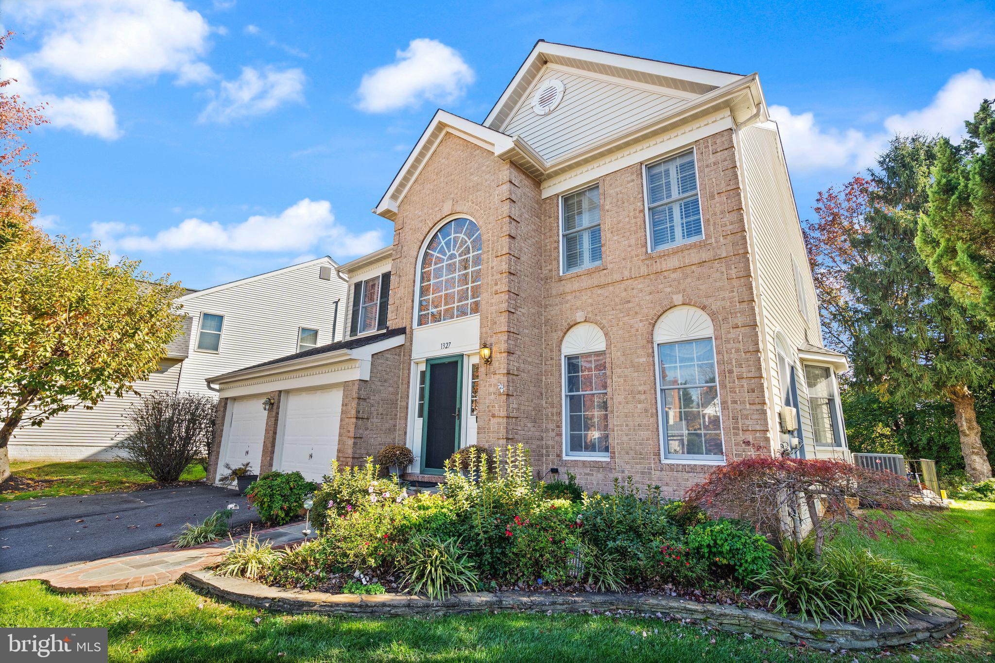 1327 Murray Downs Way Reston, VA 20194 - Photo 3 of 66 a front view of a house with a yard and potted plants