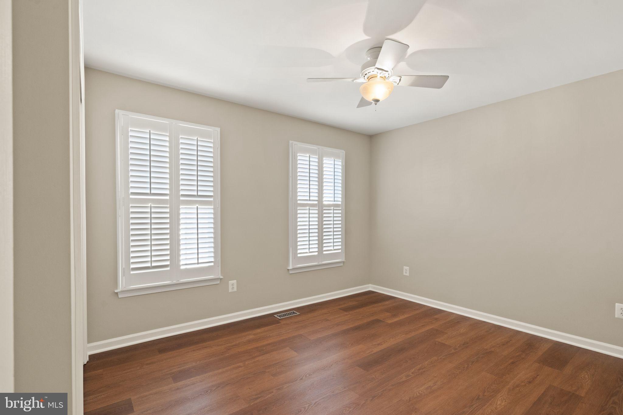 1327 Murray Downs Way Reston, VA 20194 - Photo 37 of 66 an empty room with wooden floor and windows