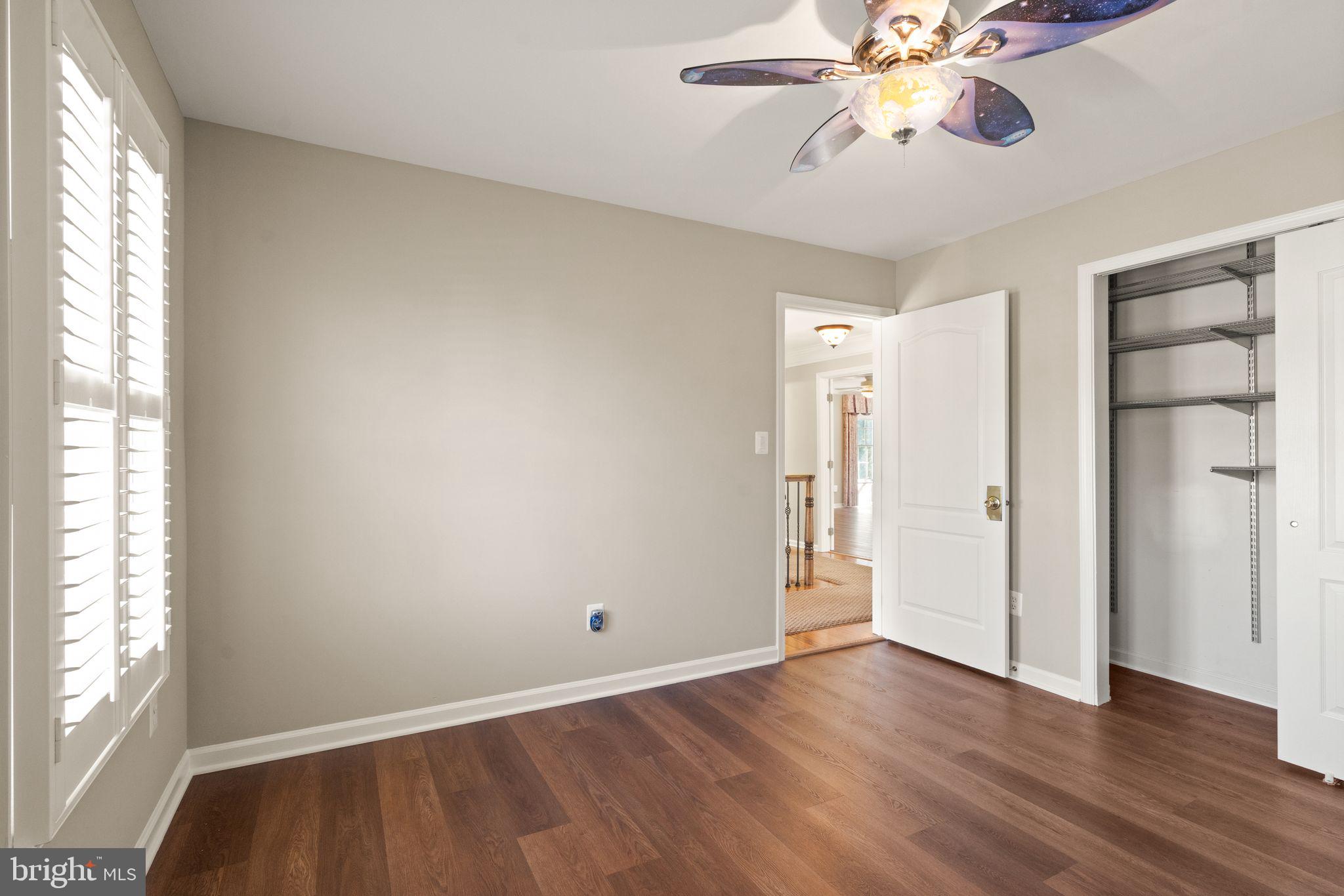 1327 Murray Downs Way Reston, VA 20194 - Photo 41 of 66 an empty room with wooden floor fan and windows