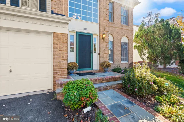 a view of a brick house with potted plants