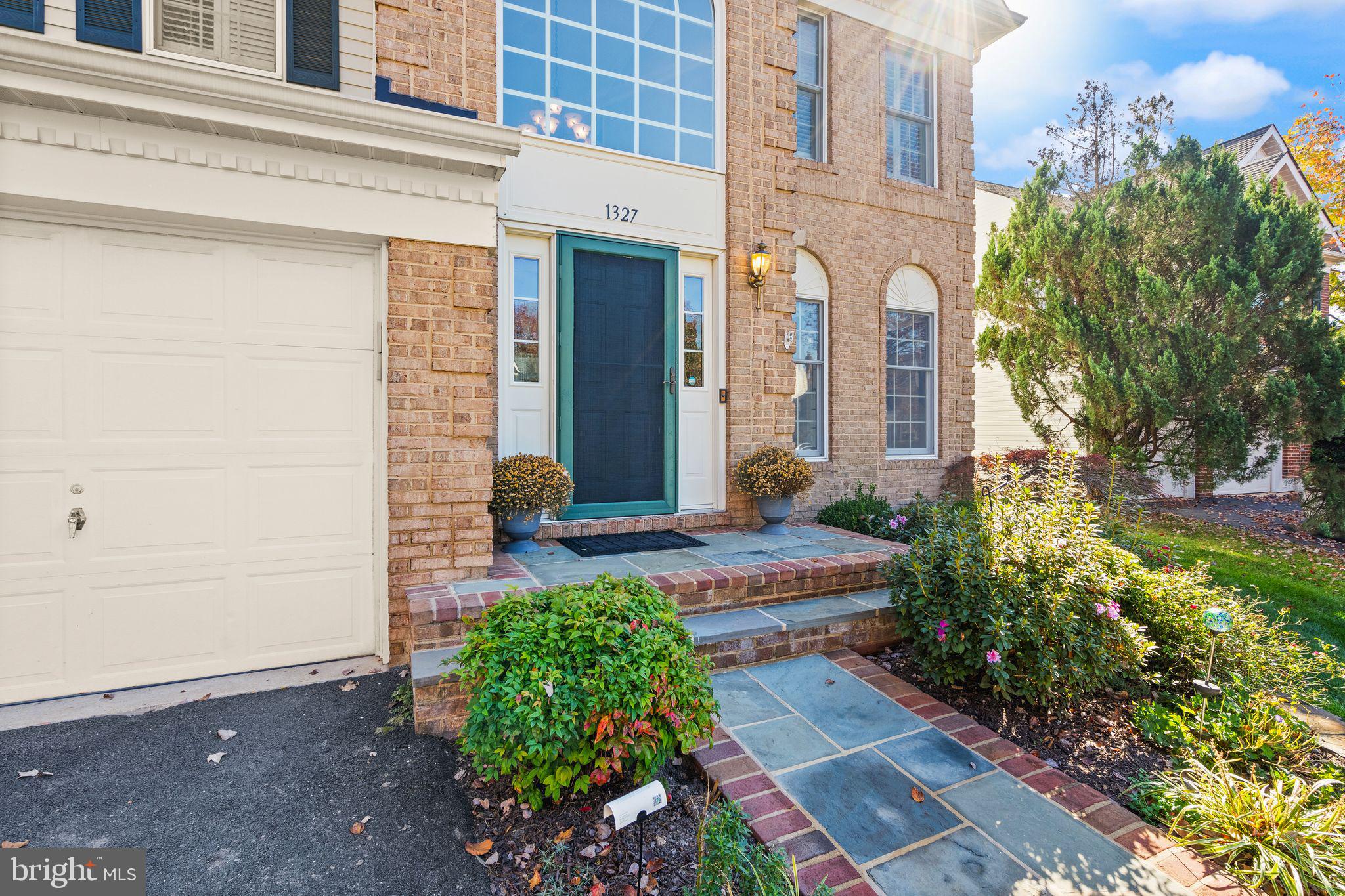 1327 Murray Downs Way Reston, VA 20194 - Photo 5 of 66 a view of a brick house with potted plants