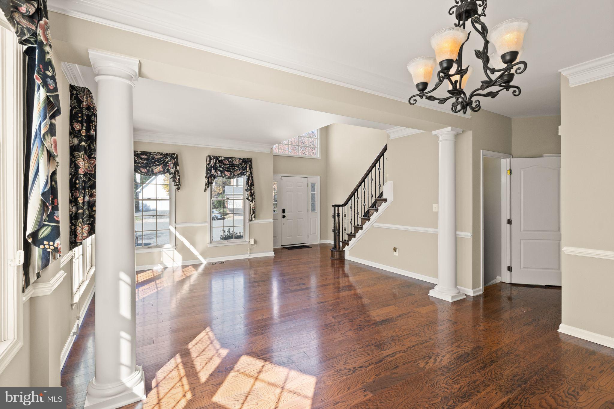 1327 Murray Downs Way Reston, VA 20194 - Photo 10 of 66 a view of an entryway with wooden floor and stairs