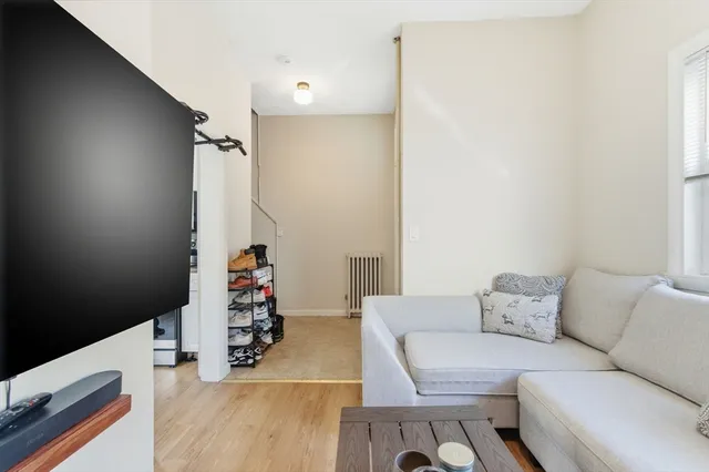 a living room with furniture and flowers