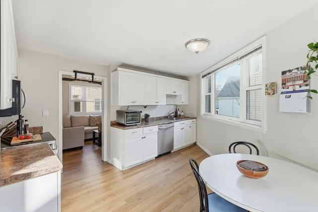 a kitchen with granite countertop a stove a sink and a refrigerator