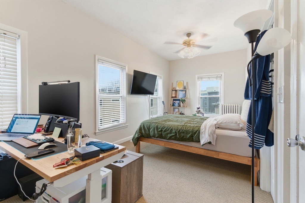 13 Knowlton Street Boston, MA 02127 - Photo 21 of 35 a bedroom with a bed and a computer on a desk next to a window