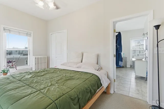 a bedroom with a bed and a large mirror