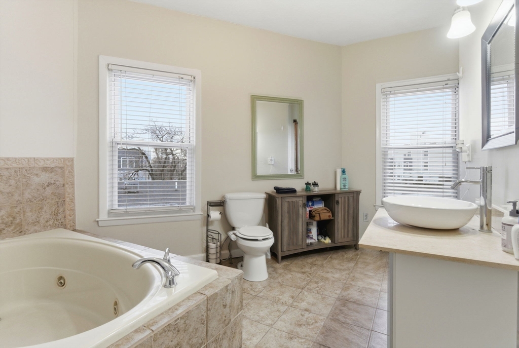 13 Knowlton Street Boston, MA 02127 - Photo 23 of 35 a bathroom with a granite countertop tub a sink and a large window