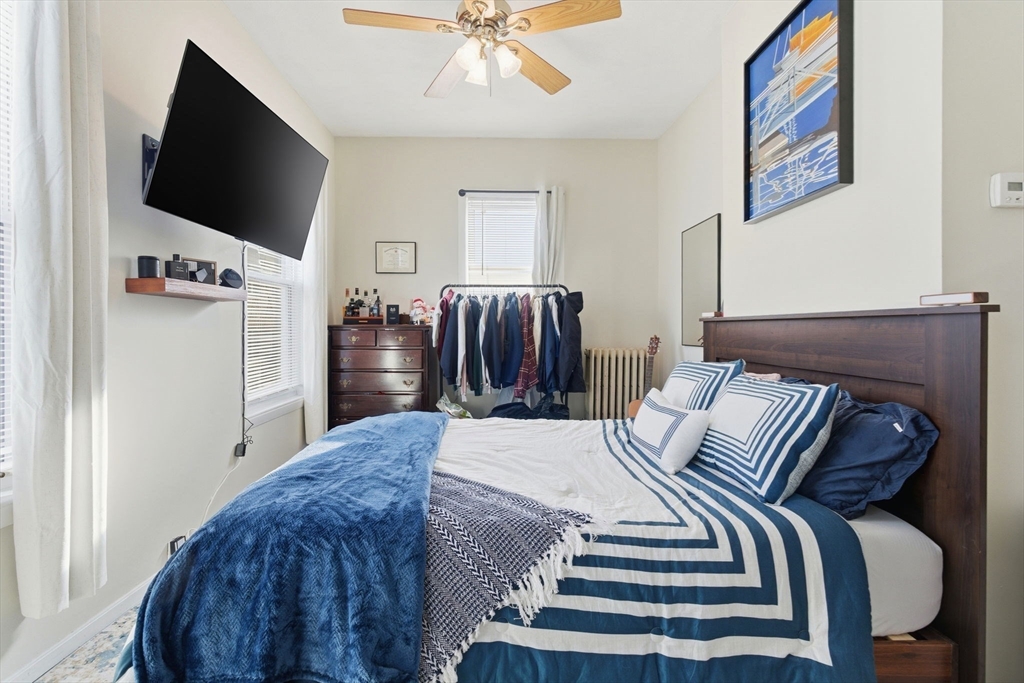 13 Knowlton Street Boston, MA 02127 - Photo 25 of 35 a bedroom with a bed and a flat screen tv