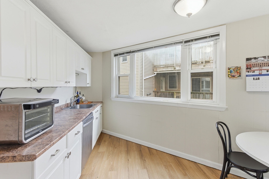 13 Knowlton Street Boston, MA 02127 - Photo 5 of 35 a kitchen that has a microwave a stove and a sink