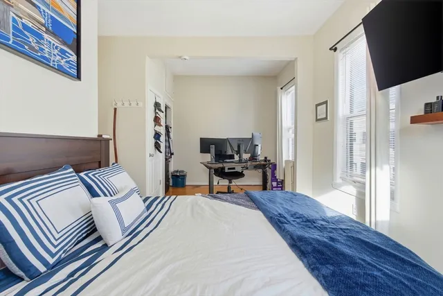 a bedroom with furniture and a rug
