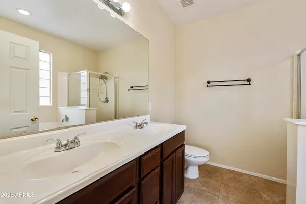 a bathroom with a sink a toilet and mirror