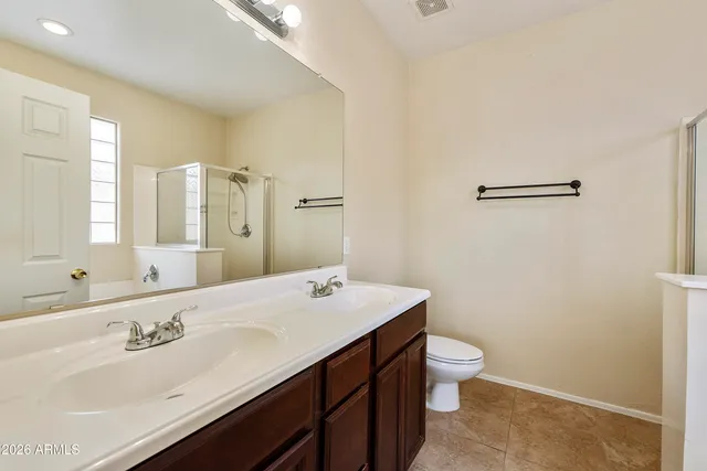 a bathroom with a sink a toilet and mirror