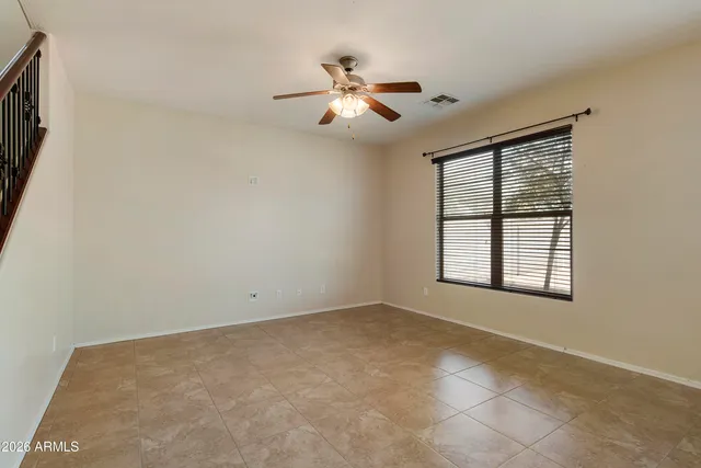 a view of a room with window and ceiling fan
