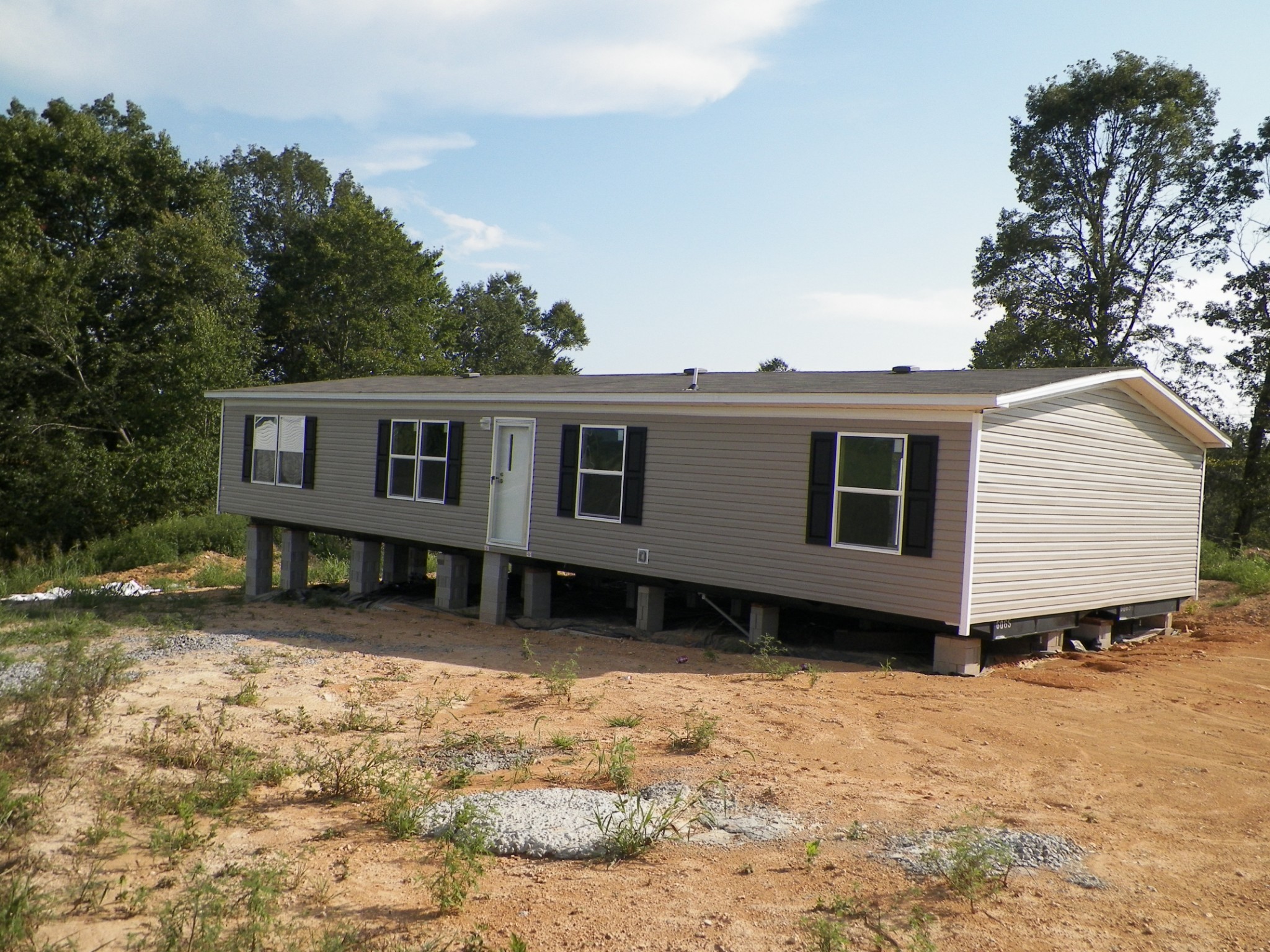 123 Claude Fox Road Lafayette, TN 37083 - Photo 1 of 1 a view of a house with a yard covered with snow in the background