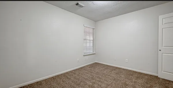 a view of empty room with windows