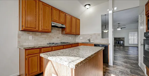 a kitchen with a stove a sink and a microwave