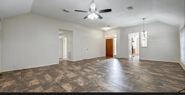 a view of a livingroom with a ceiling fan window and a chandelier fan