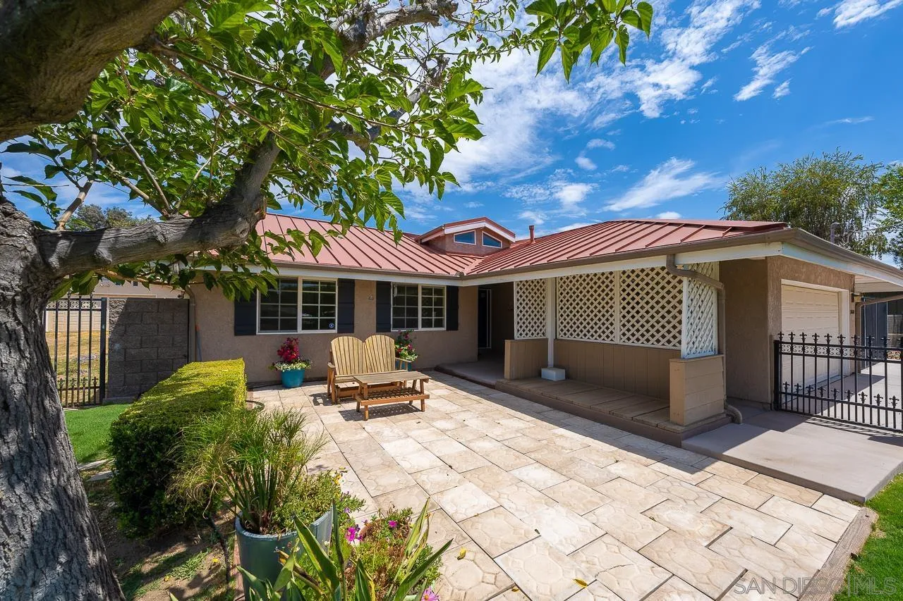 a view of a house with backyard sitting area and garden