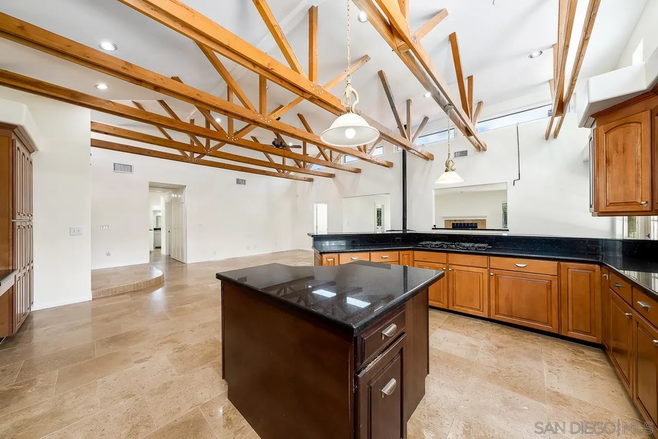 13610 Putney Road Poway, CA 92064 - Photo 11 of 62 a kitchen with stainless steel appliances granite countertop a sink a stove and a wooden floors