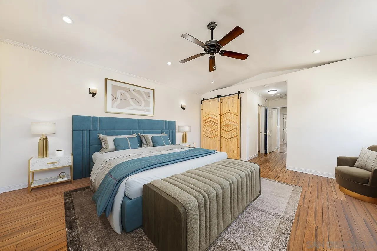 13610 Putney Road Poway, CA 92064 - Photo 17 of 62 a spacious bedroom with a large bed and a chandelier