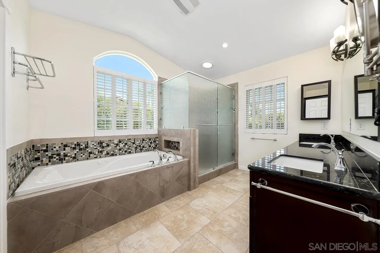 13610 Putney Road Poway, CA 92064 - Photo 19 of 62 a spacious bedroom with a bed and a window