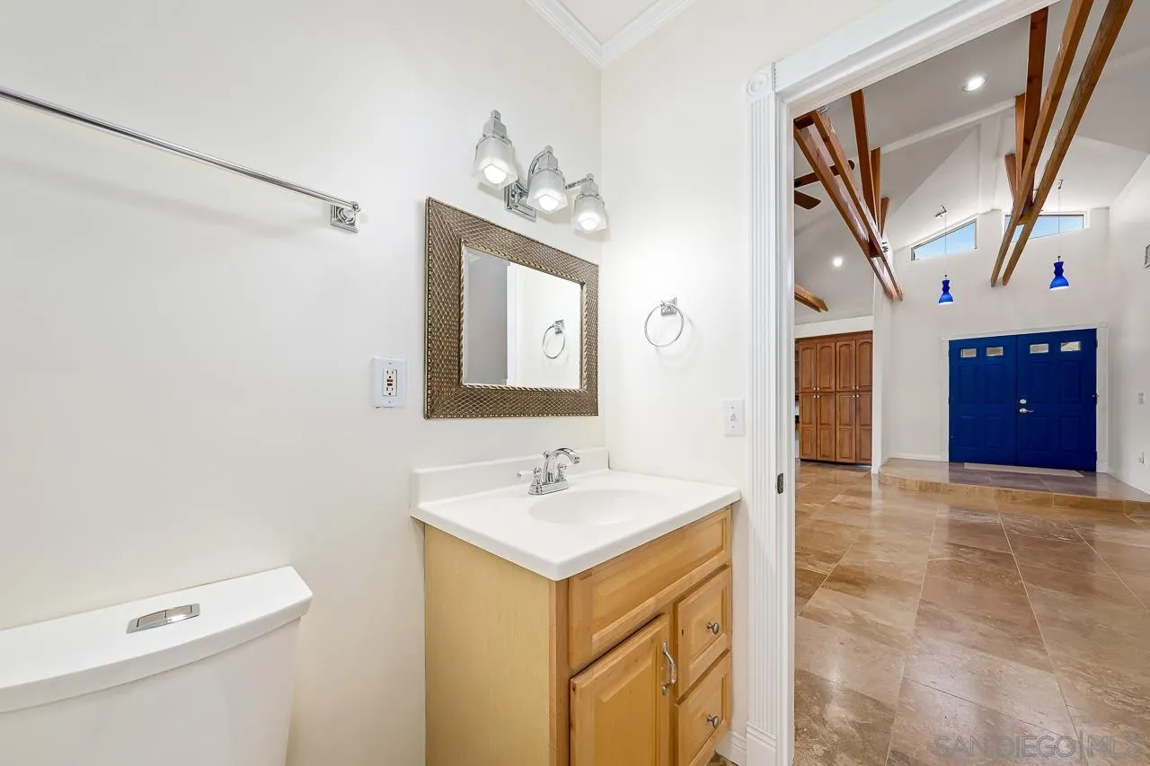 13610 Putney Road Poway, CA 92064 - Photo 24 of 62 a bathroom with a sink a toilet and mirror