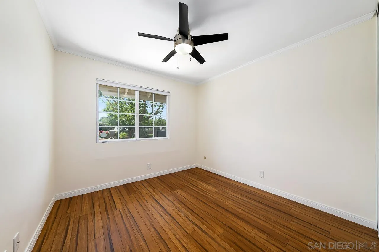 13610 Putney Road Poway, CA 92064 - Photo 27 of 62 an empty room with a window and wooden floor