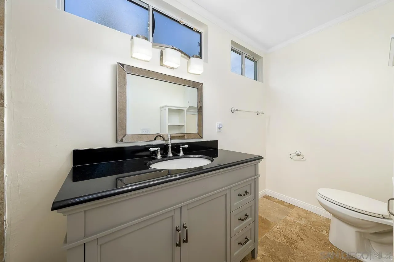 13610 Putney Road Poway, CA 92064 - Photo 29 of 62 a bathroom with a toilet sink and mirror