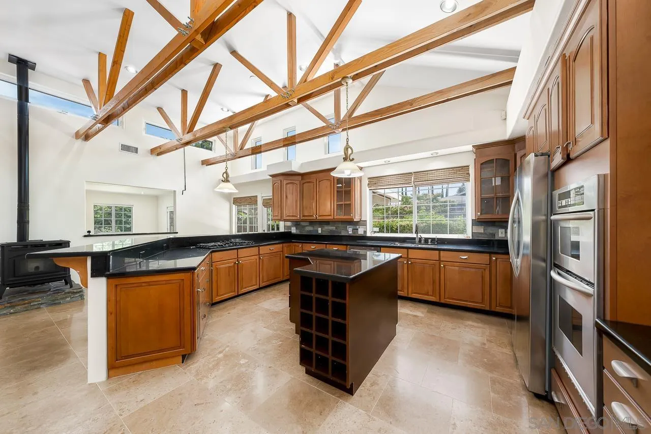 13610 Putney Road Poway, CA 92064 - Photo 10 of 62 a kitchen with stainless steel appliances granite countertop a stove a sink and a refrigerator