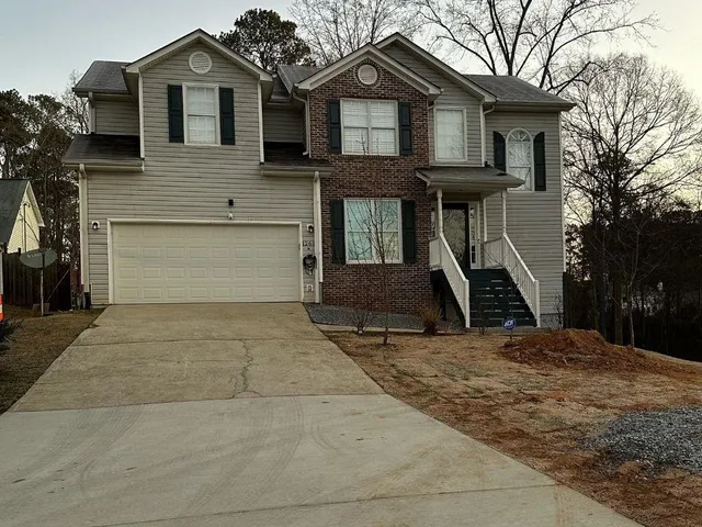 a front view of a house with a yard and garage