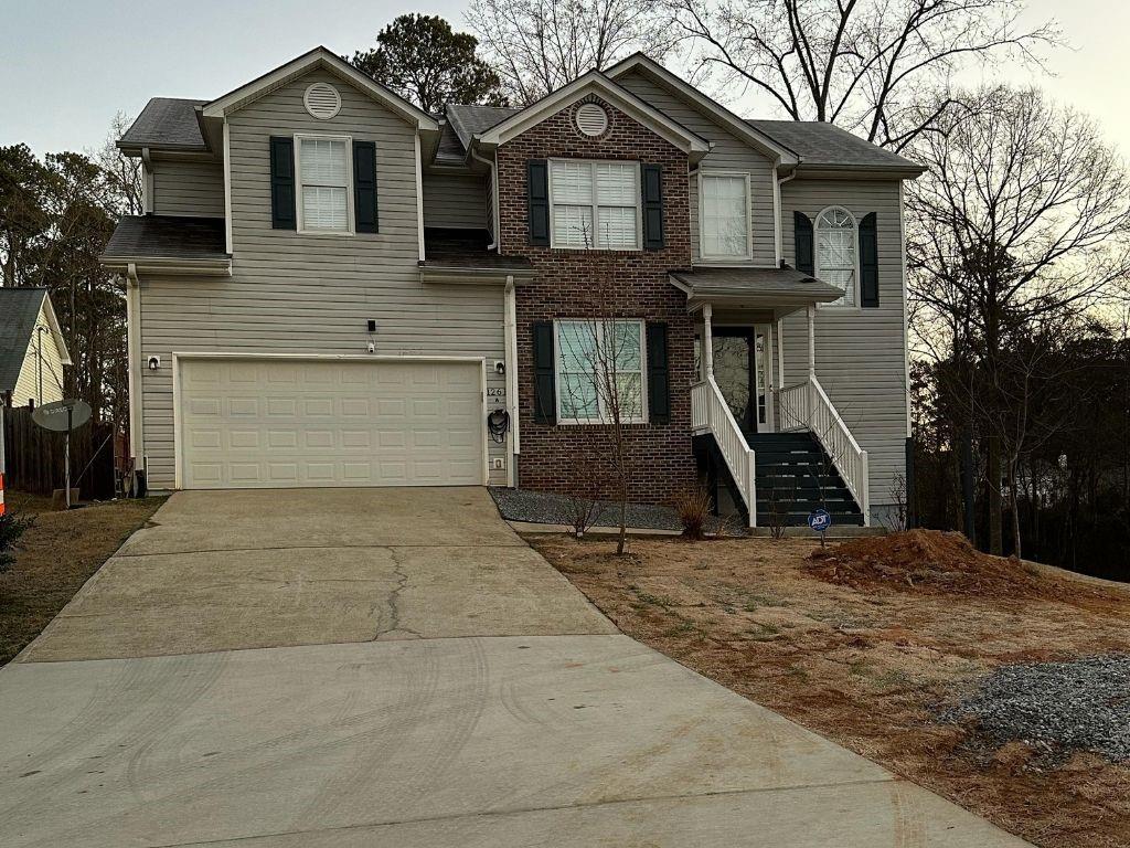 1261 Lakeview Road Grayson, GA 30017 - Photo 1 of 35 a front view of a house with a yard and garage
