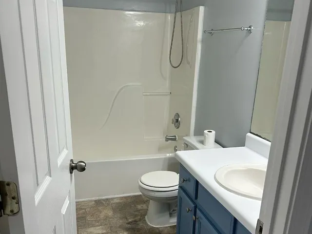 a bathroom with a sink a toilet and a shower