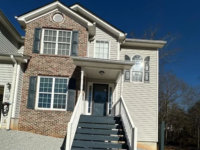 a front view of a house with a large window