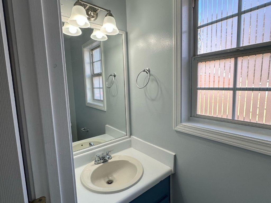 1261 Lakeview Road Grayson, GA 30017 - Photo 29 of 35 a bathroom with a sink a toilet and a mirror