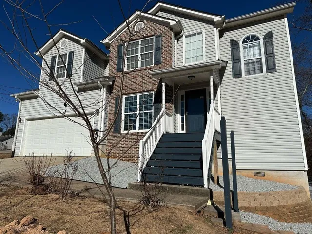 a front view of a house with wooden stairs