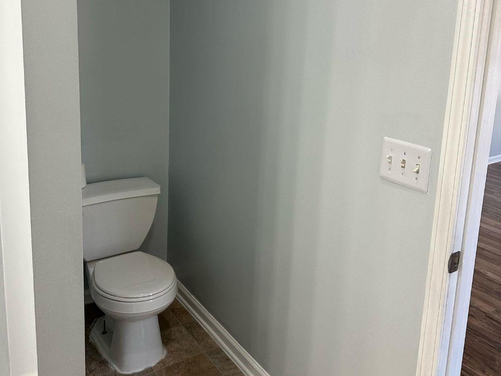 1261 Lakeview Road Grayson, GA 30017 - Photo 6 of 35 a white toilet sitting next to a white wall