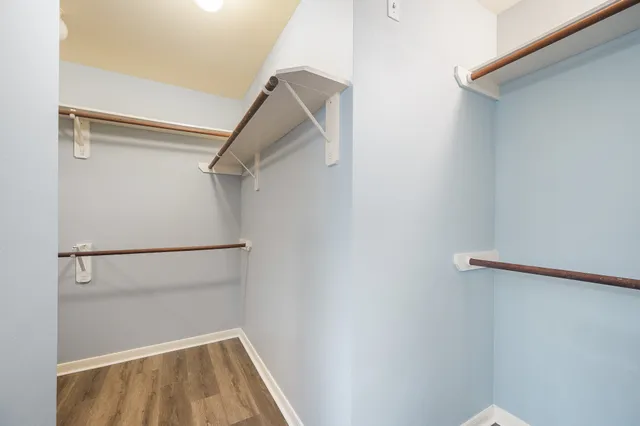 a view of walk in closet with empty racks