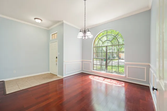a view of an entryway with wooden floor windows