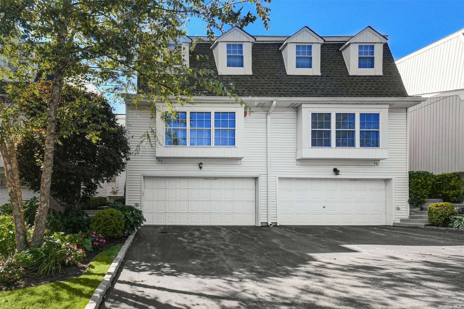 67 Hidden Ridge Drive, Unit 67 Syosset, NY 11791 - Photo 1 of 1 a front view of house with yard