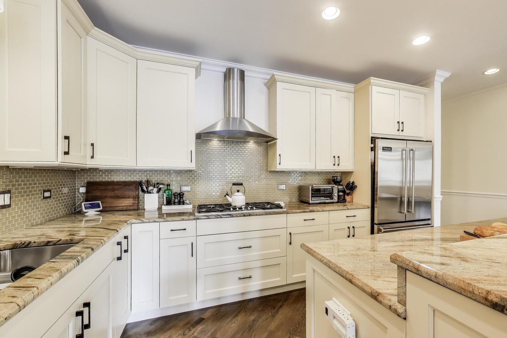 456 West Briar Place, Unit 2 Chicago, IL 60657 - Photo 11 of 25 a kitchen with granite countertop white cabinets and white appliances