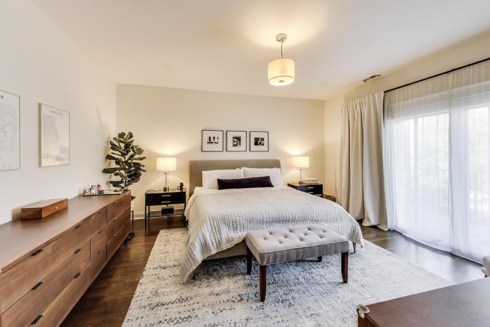 456 West Briar Place, Unit 2 Chicago, IL 60657 - Photo 13 of 25 a bedroom with a bed and a chandelier