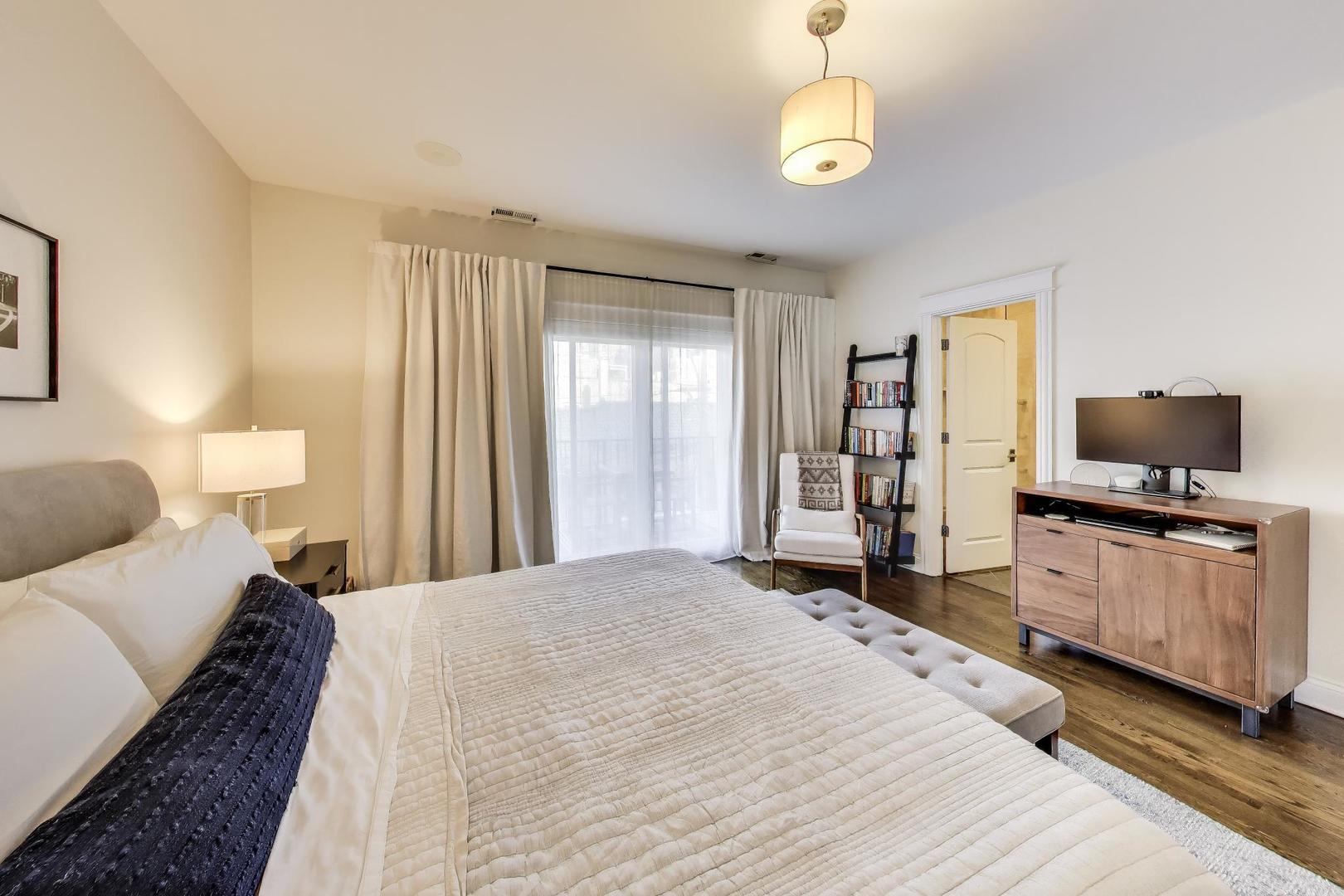 456 West Briar Place, Unit 2 Chicago, IL 60657 - Photo 14 of 25 a bedroom with a bed and wooden floor