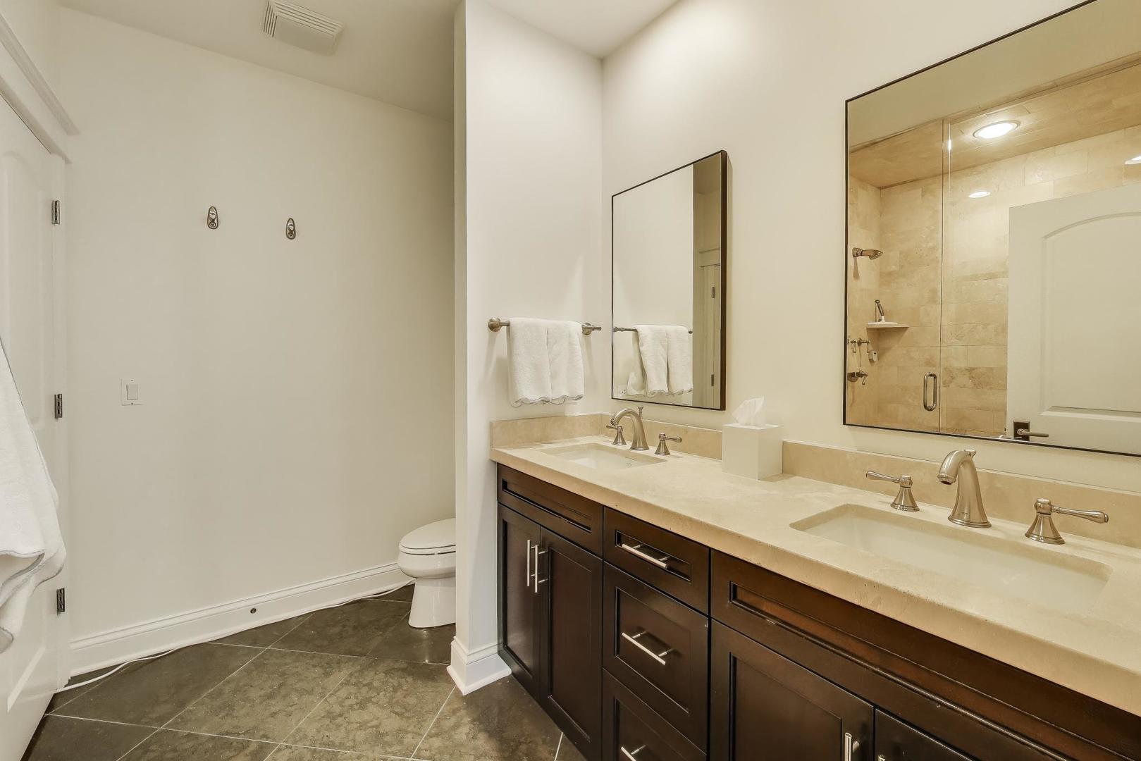 456 West Briar Place, Unit 2 Chicago, IL 60657 - Photo 16 of 25 a bathroom with a double vanity sink toilet and a mirror