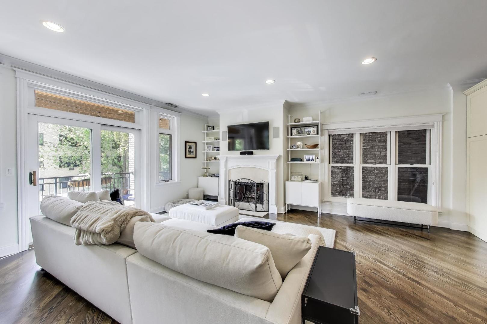 456 West Briar Place, Unit 2 Chicago, IL 60657 - Photo 4 of 25 a living room with furniture a fireplace and a large window