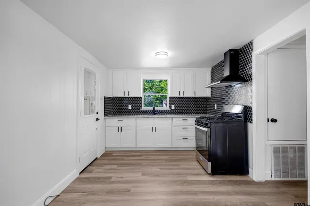 a kitchen with stainless steel appliances granite countertop a stove and a refrigerator