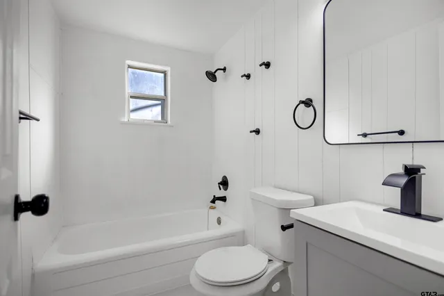 a bathroom with a sink a toilet and a tub