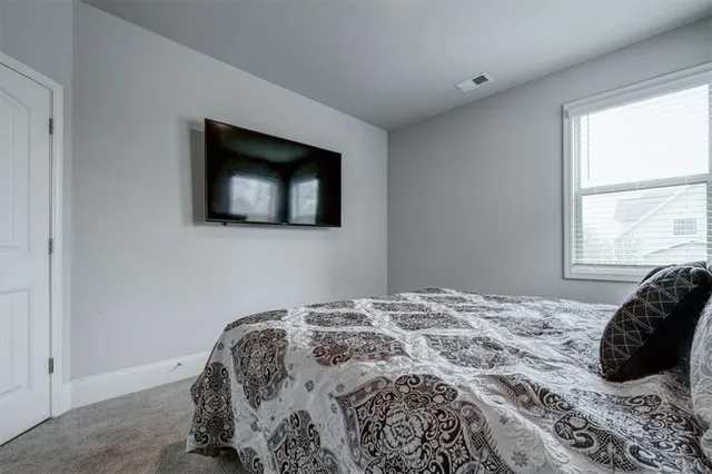 a bedroom with a bed and a television